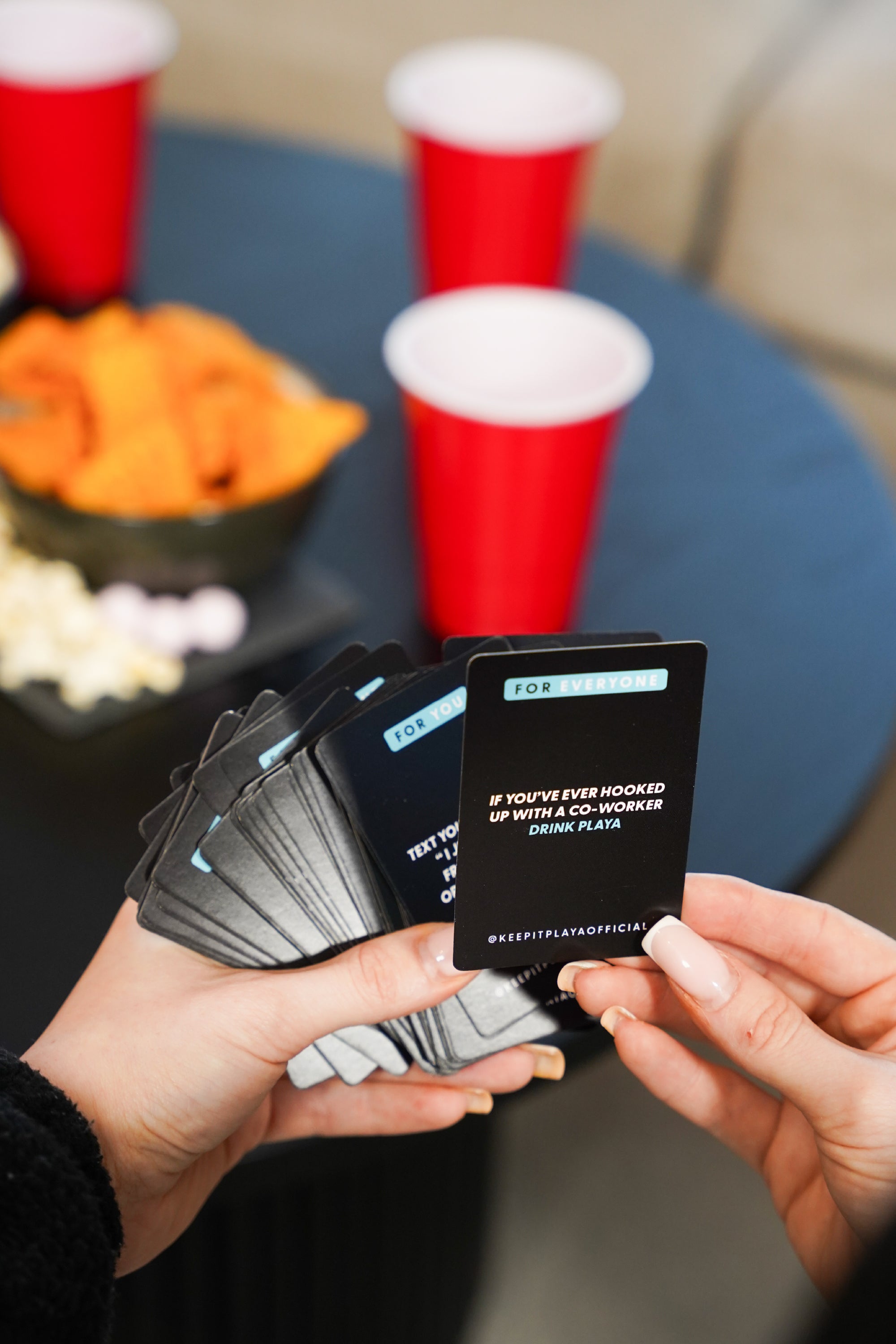 image of hand holding several Keep It Playa original edition game cards